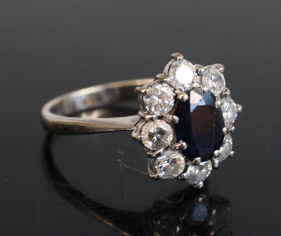 Lot 2210 - A white metal, sapphire and diamond cluster...