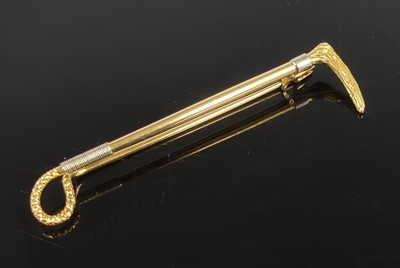 Lot 2157 - A yellow and white metal riding crop bar...