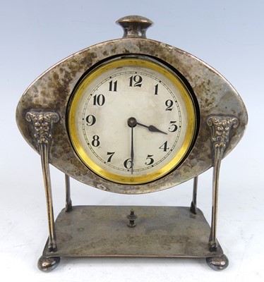 Lot 214 - An Arts & Crafts silver plated desk clock, the...