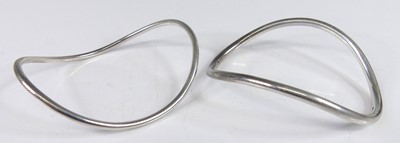 Lot 150 - A pair of contemporary silver bangles, of...