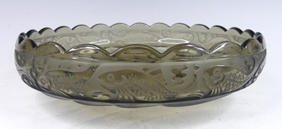 Lot 90 - A French Art Deco moulded smoky glass table...