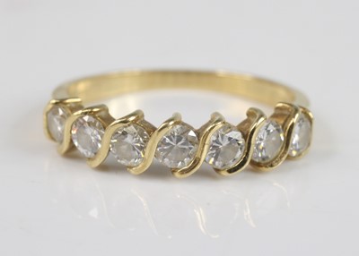 Lot 2199 - An 18ct yellow gold diamond half eternity ring,...