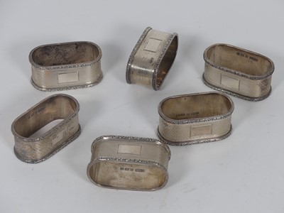 Lot 215 - A set of six Elizabeth II silver napkin rings,...