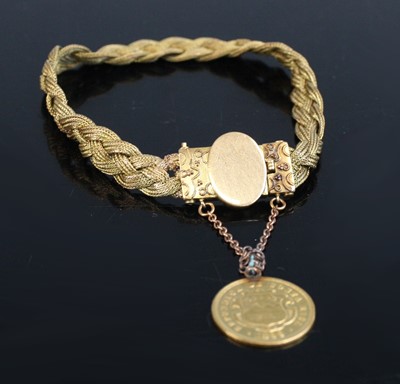 Lot 2222 - A 14ct gold fancy bracelet, arranged as...
