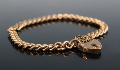 Lot 2220 - A 9ct gold curblink bracelet, having a heart...