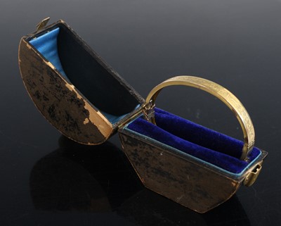 Lot 2174 - A Victorian gold-plated engraved hinged bangle,...