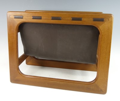 Lot 415 - A 1970s teak magazine stand, having a hide...