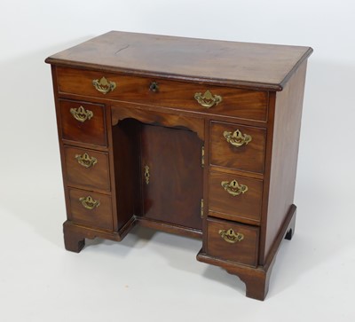 Lot 2453 - An early George III mahogany kneehole desk,...