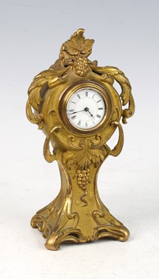 Lot 213 - A French Art Nouveau gilt metal bedside clock,...