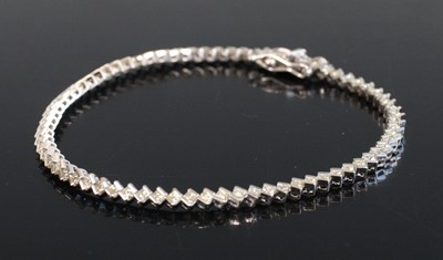 Lot 2235 - A white metal diamond tennis bracelet,...