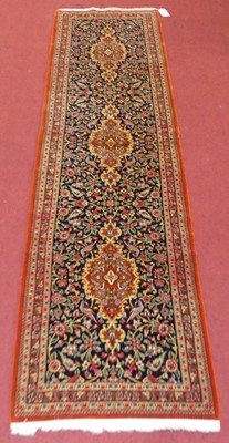 Lot 1147 - A Persian Qum woollen hall runner, having...