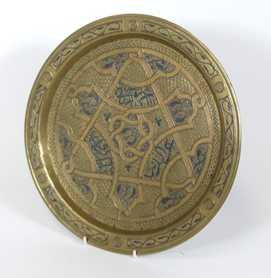 Lot 7 - A Persian brass and niello decorated tray, d.32cm