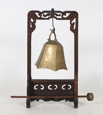 Lot 39 - A Chinese brass bell, on carved wooden stand,...