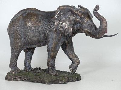 Lot 94 - A bronzed resin figure of an elephant,...