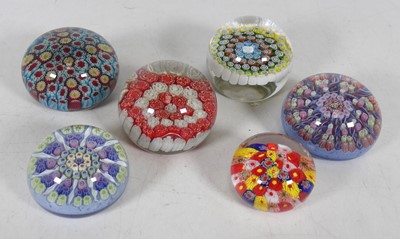 Lot 133 - A group of six millefiore glass paperweights,...