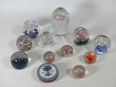Lot 147 - A collection of studio glass paperweights, to...