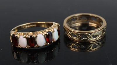 Lot 252 - A 9ct gold opal and garnet set half eternity...