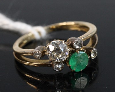 Lot 262 - An 18ct gold emerald and diamond set crossover...