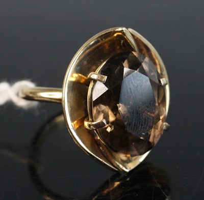 Lot 263 - A modern yellow metal smoky topaz dress ring,...
