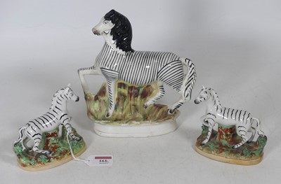 Lot 161 - A Staffordshire pottery figure of a zebra,...