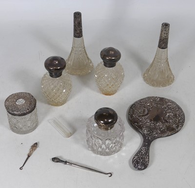 Lot 168 - A pair of cut glass scent bottles, with hinged...