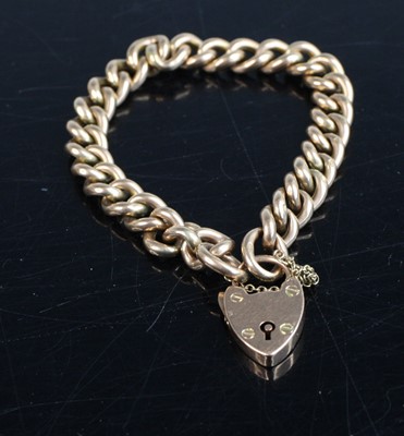 Lot 289 - A 9ct gold curb link bracelet having heart...