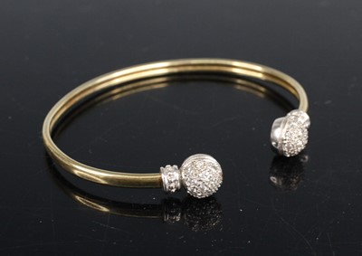 Lot 303 - A yellow metal cuff bangle with paste set...