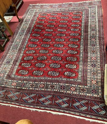 Lot 1143 - A Persian woollen red ground Bokhara rug, the...
