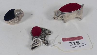 Lot 318 - Three novelty silver pin cushions, being a pig,...