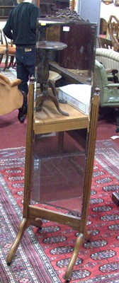 Lot 1170 - A 1930s oak framed and bevelled cheval mirror,...