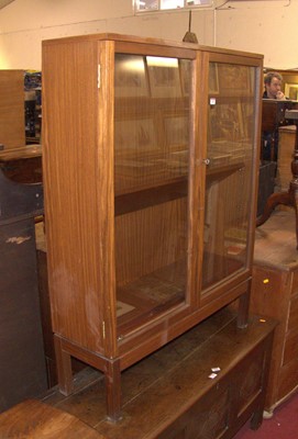 Lot 1187 - A 1970s teak double door glazed bookcase,...