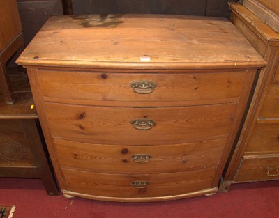 Lot 1190 - A rustic pine bowfront chest of four long...