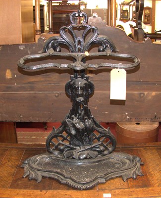 Lot 1220 - A black painted, pierced and cast iron twin...