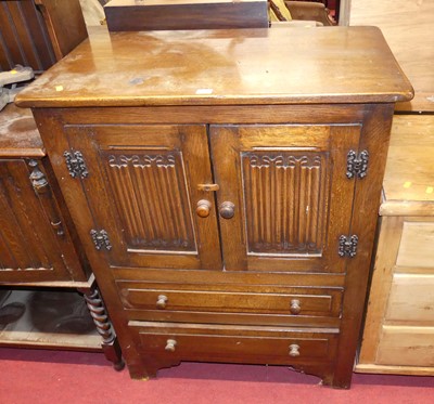 Lot 1230 - A joined oak linenfold panelled double door...