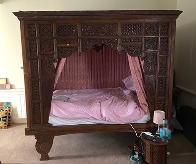 Lot 1324 - An antique carved and joined stained teak...