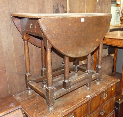 Lot 1249 - An antique oak gateleg table, having single...