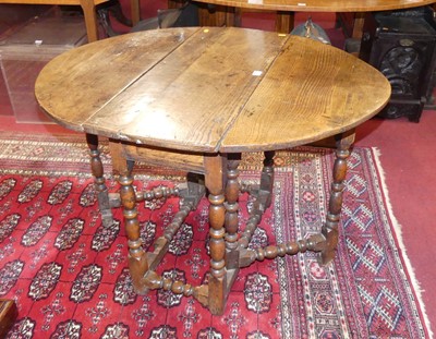 Lot 1260 - An antique joined oak gateleg table, having...