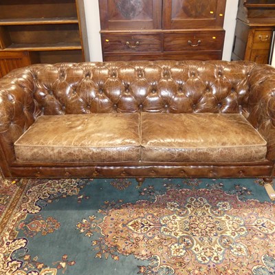 Lot 1262 - A contemporary brown leather buttoned...