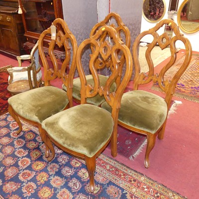 Lot 1294 - A set of four continental walnut pierced back...