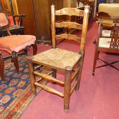 Lot 1300 - A pair of mahogany open armchairs, in the...