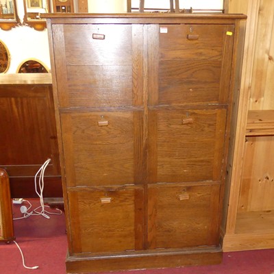 Lot 1338 - An early 20th century oak six door filing...