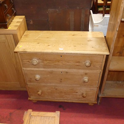 Lot 1354 - A rustic pine chest of three long drawers,...