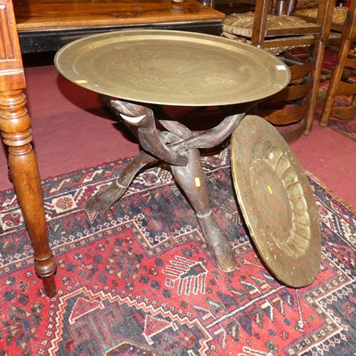 Lot 1370 - A circular engraved brass topped Benares table,...