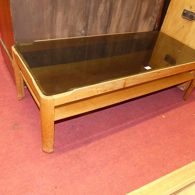 Lot 1381 - A 1970s teak and smoky glass topped two-tier...