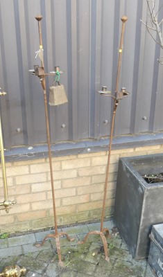 Lot 1385 - A pair of iron twin freestanding candle stands,...