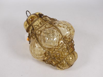 Lot 395 - An amber metal mounted glass ceiling light,...