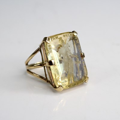 Lot 2014 - A yellow metal citrine intaglio ring featuring...