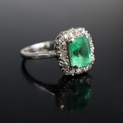 Lot 2058 - A white metal emerald and diamond oblong...