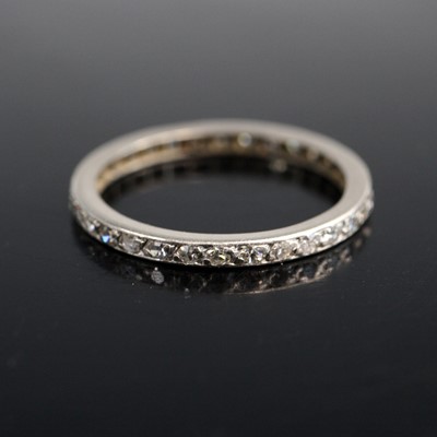Lot 2059 - A white metal diamond eternity ring featuring...