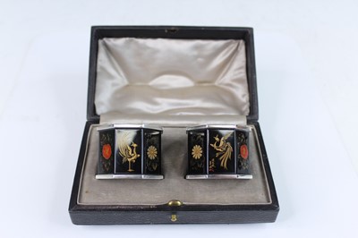 Lot 5 - A pair of Japanese black and gilt-enamelled...